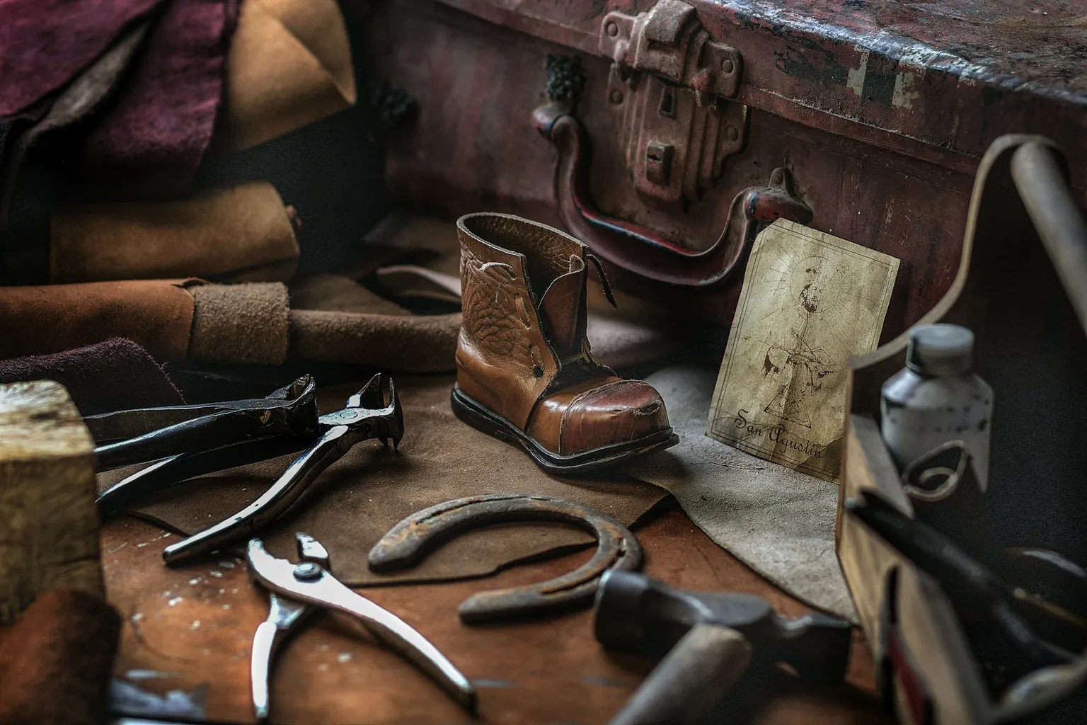 Cobbler’s workbench with a leather boot, pliers and hand tools